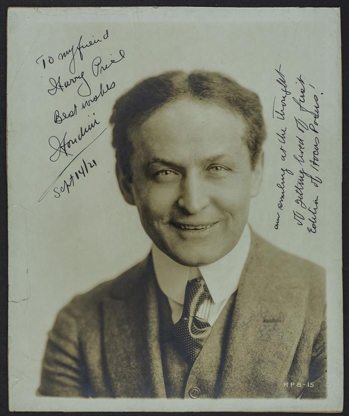Houdini performing his handcuff escapePhotograph of Houdini, signed to Harry Price